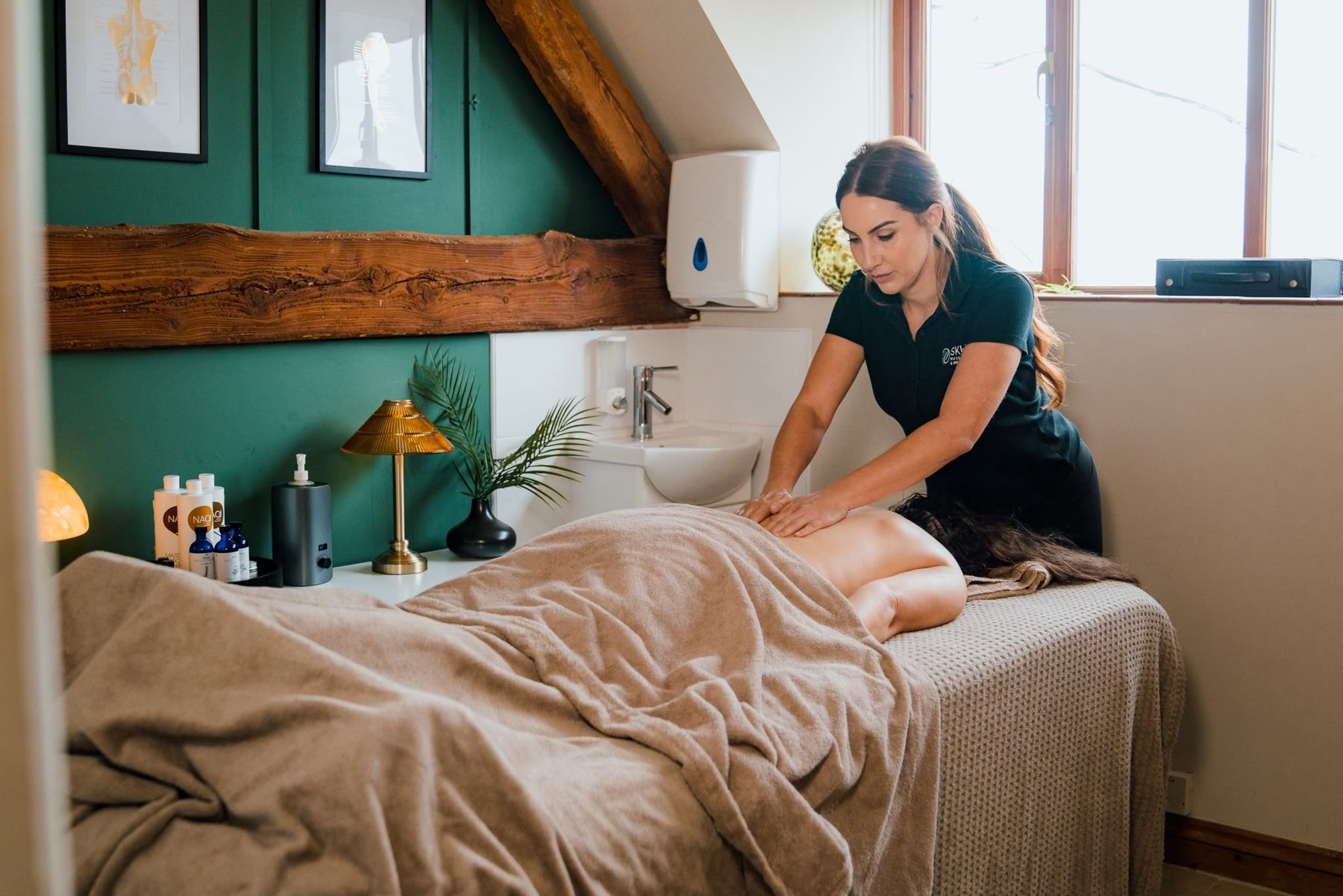 Sophie giving a back massage in the treatment room at Oldwick Farm