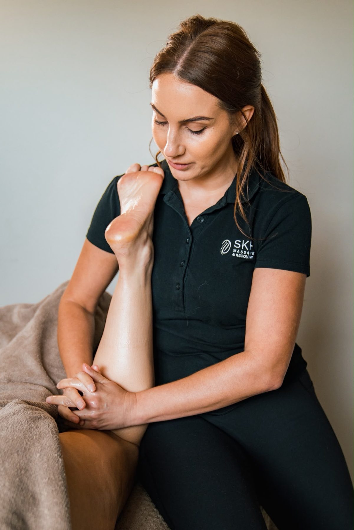 Sophie stretching a client's calf